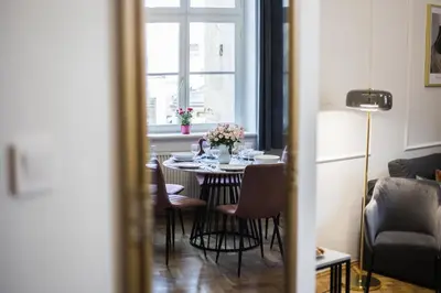 a dining room table with flowers on top of it at CracWoW K8 No.11 Apartment in Kraków