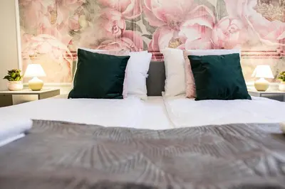 a bedroom with a bed with green and white pillows at CracWoW K8 No.11 Apartment in Kraków