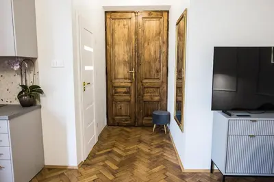 a hallway with a wooden door in a room at CracWoW K8 No.11 Apartment in Kraków