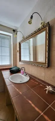 a bathroom with a sink and a mirror at La Casa De Roland in Wieliczka