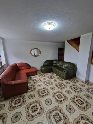a living room with leather furniture and a rug at La Casa De Roland in Wieliczka