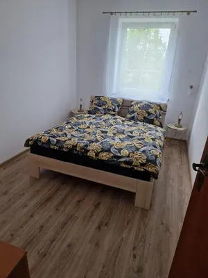 a bedroom with a bed in a room with a window at La Casa De Roland in Wieliczka