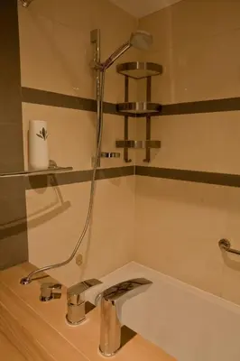 a shower in a bathroom with a sink at Magic Apartment in Kraków