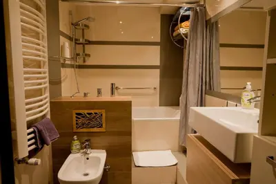a bathroom with a sink and a toilet and a tub at Magic Apartment in Kraków