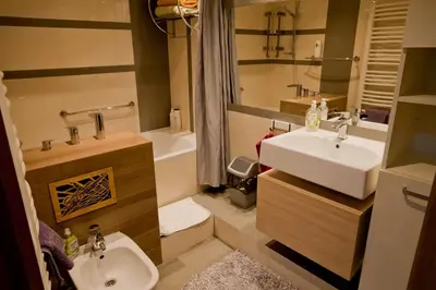 a bathroom with a sink and a toilet and a tub at Magic Apartment in Kraków