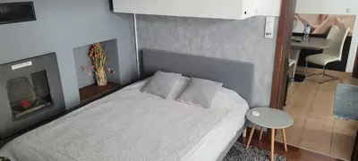 a bedroom with a white bed with a fireplace at Magic Apartment in Kraków