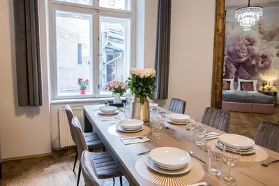 a dining room with a long table with chairs at CracWoW K8 No.1 Apartment in Kraków