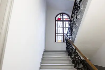 a staircase in a building with a window at CracWoW K8 No.1 Apartment in Kraków