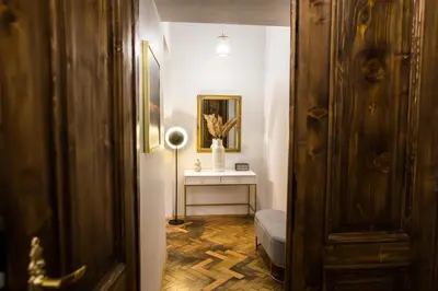 a hallway with a room with a table and a lamp at CracWoW K8 No.1 Apartment in Kraków