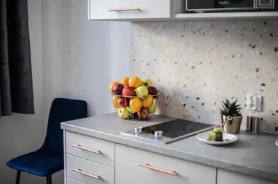 a bowl of fruit on a counter in a kitchen at CracWoW K8 No.2 Apartment in Kraków