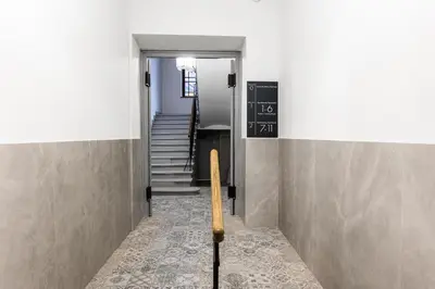 a hallway with stairs and a chalkboard on the wall at CracWoW K8 No.2 Apartment in Kraków