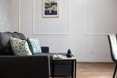 a living room with a couch and a table at CracWoW K8 No.2 Apartment in Kraków