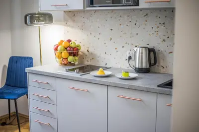 a kitchen with a bowl of fruit on the counter at CracWoW K8 No.8 Apartment in Kraków