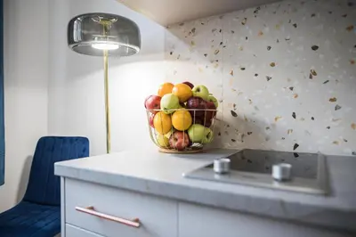 a bowl of fruit on a counter in a kitchen at CracWoW K8 No.8 Apartment in Kraków