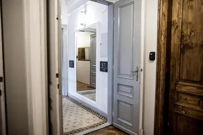 a hallway with a door and a mirror at CracWoW K8 No.8 Apartment in Kraków
