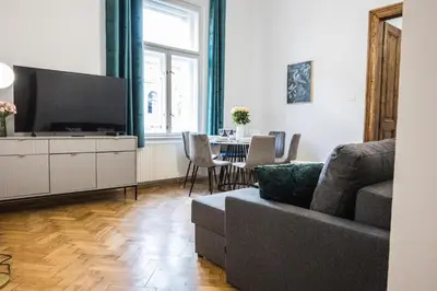 a living room with a couch and a flat screen tv at CracWoW K8 No.8 Apartment in Kraków