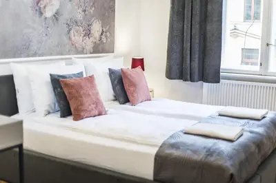 a large white bed with pillows on top of it at CracWoW K8 No.9 Apartment in Kraków