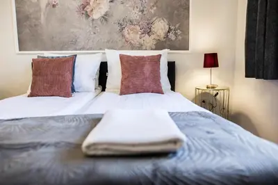 a bed with a blanket on top of it at CracWoW K8 No.9 Apartment in Kraków