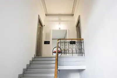 a staircase in a building with a chair on it at CracWoW K8 No.9 Apartment in Kraków