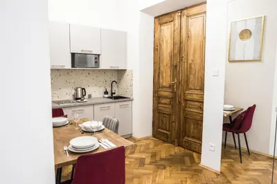 a kitchen and dining room with a table and chairs at CracWoW K8 No.9 Apartment in Kraków