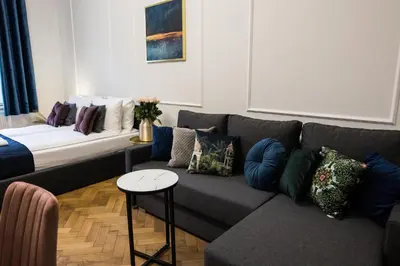 a living room with a couch with pillows on it at CracWoW K8 No.10 Apartment in Kraków