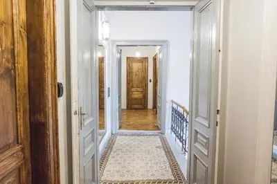 a hallway with a door leading into a room at CracWoW K8 No.10 Apartment in Kraków