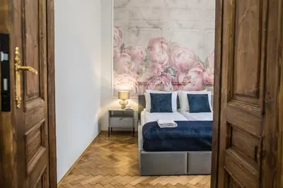 a bedroom with a bed and a painting on the wall at CracWoW K8 No.10 Apartment in Kraków