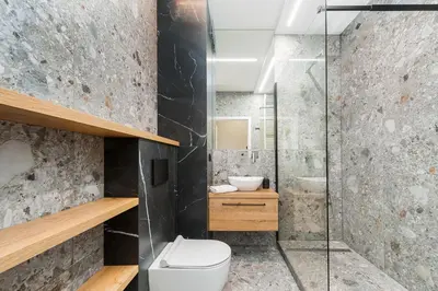 a bathroom with a toilet and a glass shower at Krakowiak Apartment 65 in Kraków