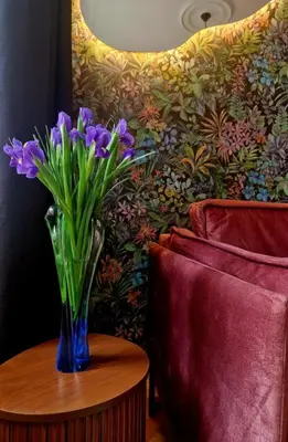 a vase of purple flowers sitting on a table at Flora Design Old Town- Free Parking in Kraków