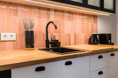 a kitchen with a sink and a counter top at Flora Design Old Town- Free Parking in Kraków