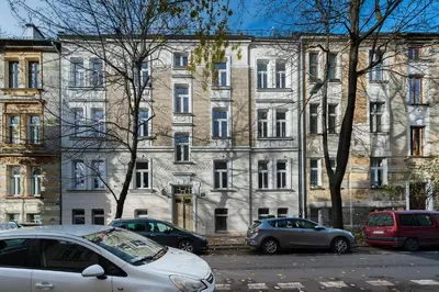 a large building with cars parked in front of it at Flora Design Old Town- Free Parking in Kraków