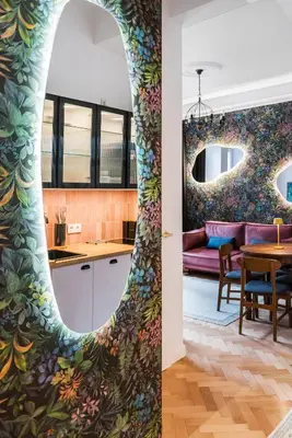 a kitchen and living room with a colorful wall at Flora Design Old Town- Free Parking in Kraków