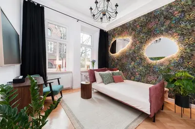 a living room with a couch and a flower wall at Flora Design Old Town- Free Parking in Kraków
