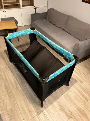 a bed frame with a futon in a living room at FeelHome Apartment with kitchen in Kraków