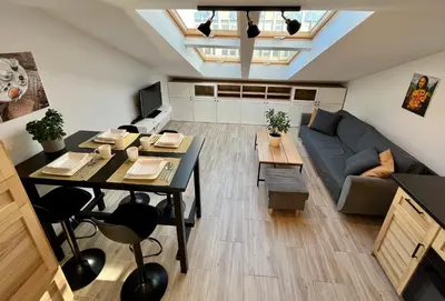 a living room with a table and a couch at FeelHome Apartment with kitchen in Kraków