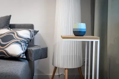 a blue bowl on a table next to a chair at Kraków Central Comfort Apartments by Rentujemy in Kraków