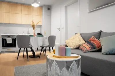 a living room with a couch and a table at Kraków Central Comfort Apartments by Rentujemy in Kraków