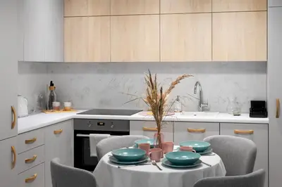 a kitchen with a table with plates and bowls on it at Kraków Central Comfort Apartments by Rentujemy in Kraków