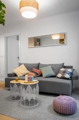 a living room with a couch and a table at Kraków Central Comfort Apartments by Rentujemy in Kraków