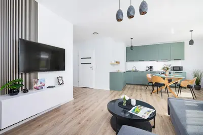 a living room with a couch and a table at Cracow Apartment Bronowicka with Parking by Noclegi Renters in Kraków