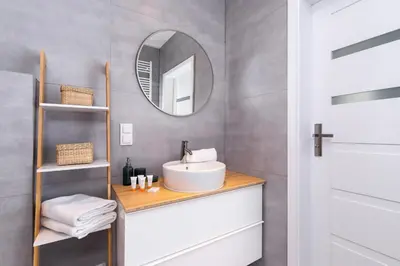 a bathroom with a sink and a mirror at Cracow Apartment Bronowicka with Parking by Noclegi Renters in Kraków