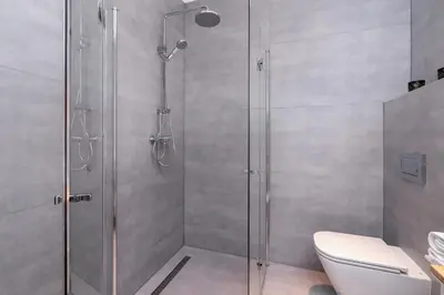 a shower stall in a bathroom with a toilet at Cracow Apartment Bronowicka with Parking by Noclegi Renters in Kraków
