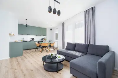 a living room with a couch and a table at Cracow Apartment Bronowicka with Parking by Noclegi Renters in Kraków