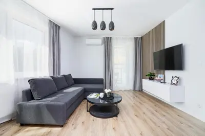 a living room with a couch and a table at Cracow Apartment Bronowicka with Parking by Noclegi Renters in Kraków