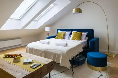 a bedroom with a large bed with a blue headboard at Charming apartment in perfect location in Kraków