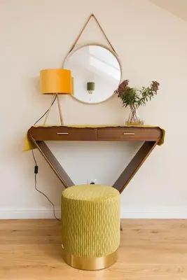 a dressing table with a mirror and a stool at Charming apartment in perfect location in Kraków