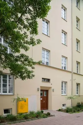 a large white building with a brown door at Charming apartment in perfect location in Kraków