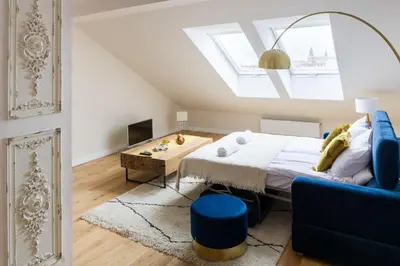 a bedroom with a bed and a blue couch at Charming apartment in perfect location in Kraków