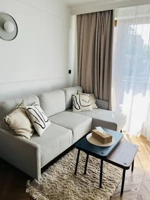 a living room with a couch and a table with a cake at Apartament BonHaus Grzegórzecka in Kraków