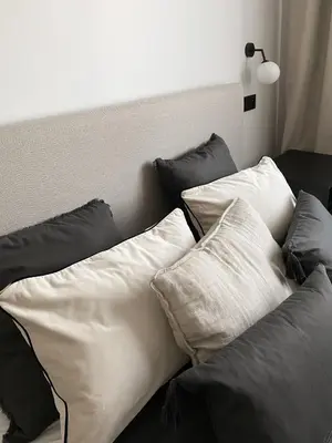 a group of pillows sitting on top of a bed at Apartament BonHaus Grzegórzecka in Kraków